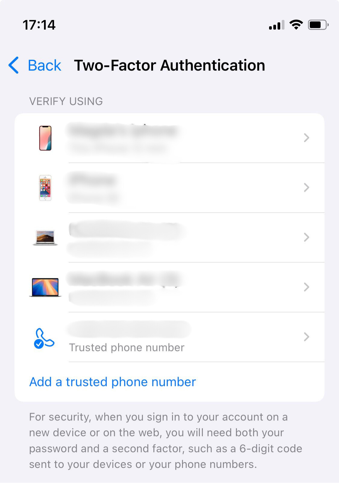 A list of trusted devices on an iPhone with an option to add a trusted phone number.